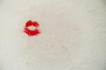 Red lip marks on a wall.